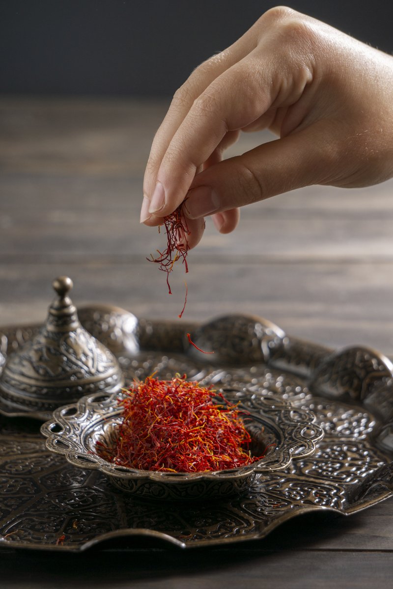 Hands carefully picking saffron crocus flowers during the harvest in Taliouine